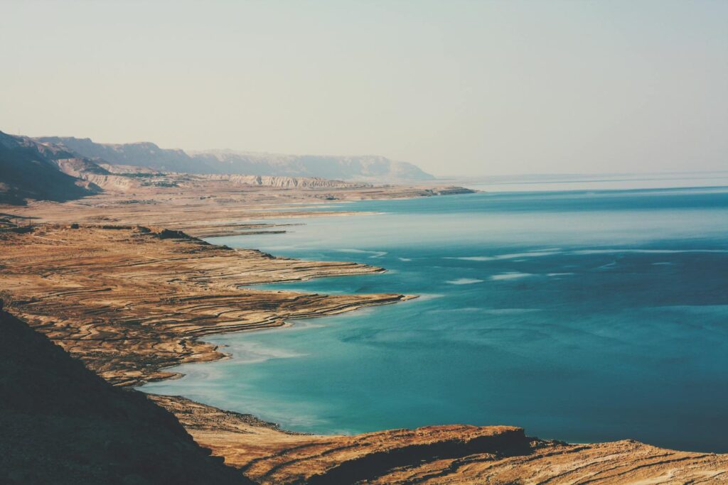 A breathtaking aerial view of the Dead Sea's coastline, capturing its rugged beauty and serene blue waters.