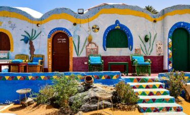 Vibrant Nubian house facade with colorful walls and traditional decor in Egypt's rural area.