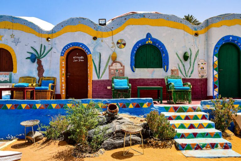 Vibrant Nubian house facade with colorful walls and traditional decor in Egypt's rural area.
